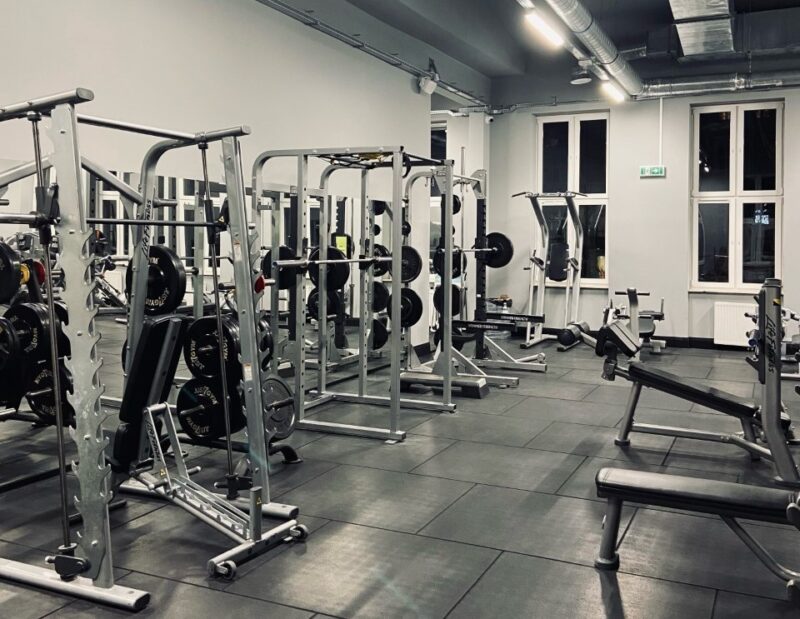 A room with exercise lifts on which barbells and weights are stacked.